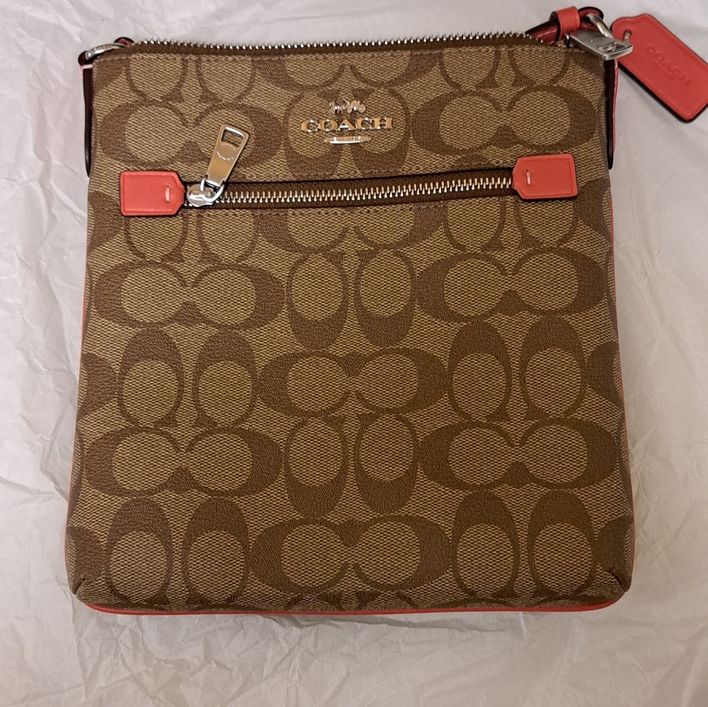 Coach mini rowan file bag in signature canvas. Color is SV/KHAKI/TANGERINE.